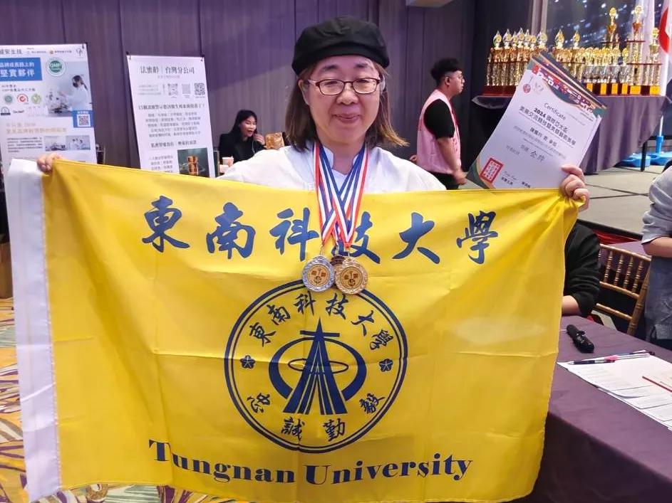 圖三:陳姵均同學手持東南科技大學旗幟及獎牌,展現參賽成果,為校爭光。